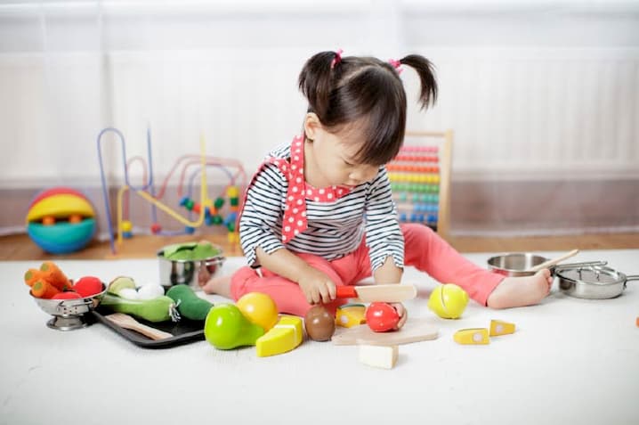 girl playing pretend kitchen