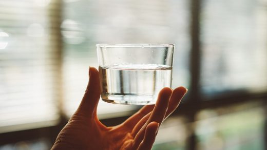 picture of a hand holding a glass of fresh clean water