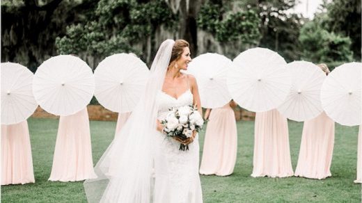 Ladies with white wedding umbrellas