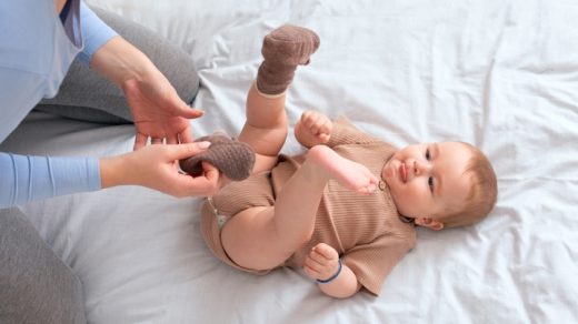 mom fixing her babys socks