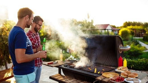 friends are having barbeque in the garden on a bbq smoker