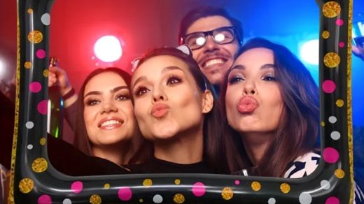 group of people taking pictures with selfie frame
