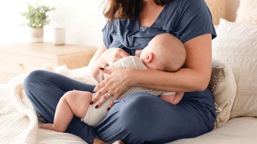 woman wearing nursing sleepwear and breastfeeding her baby