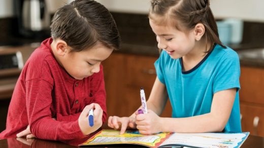 boy and girl in kindergarten learning math with singapore mathematics textbook