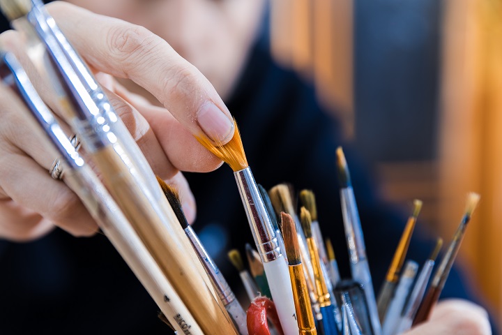 man choosing a paintbrush