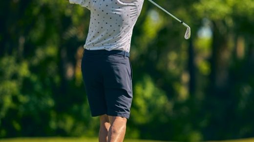 a person playing on a golf field