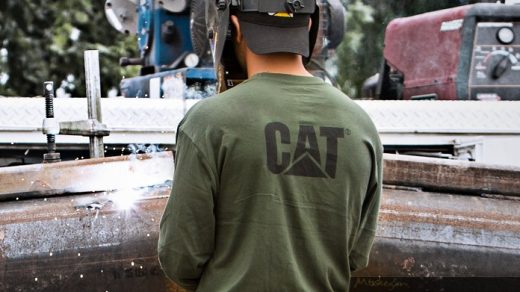 man working and wearing CAT workwear