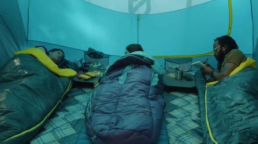 people sleeping in synthetic sleeping bag in a tent