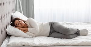 woman lying on a comfortable mattress