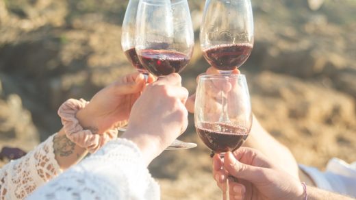 friends making a toast with a red wine